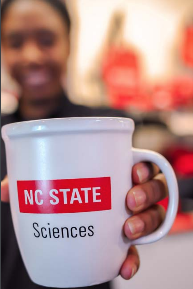 An NC State Sciences-branded coffee mug.